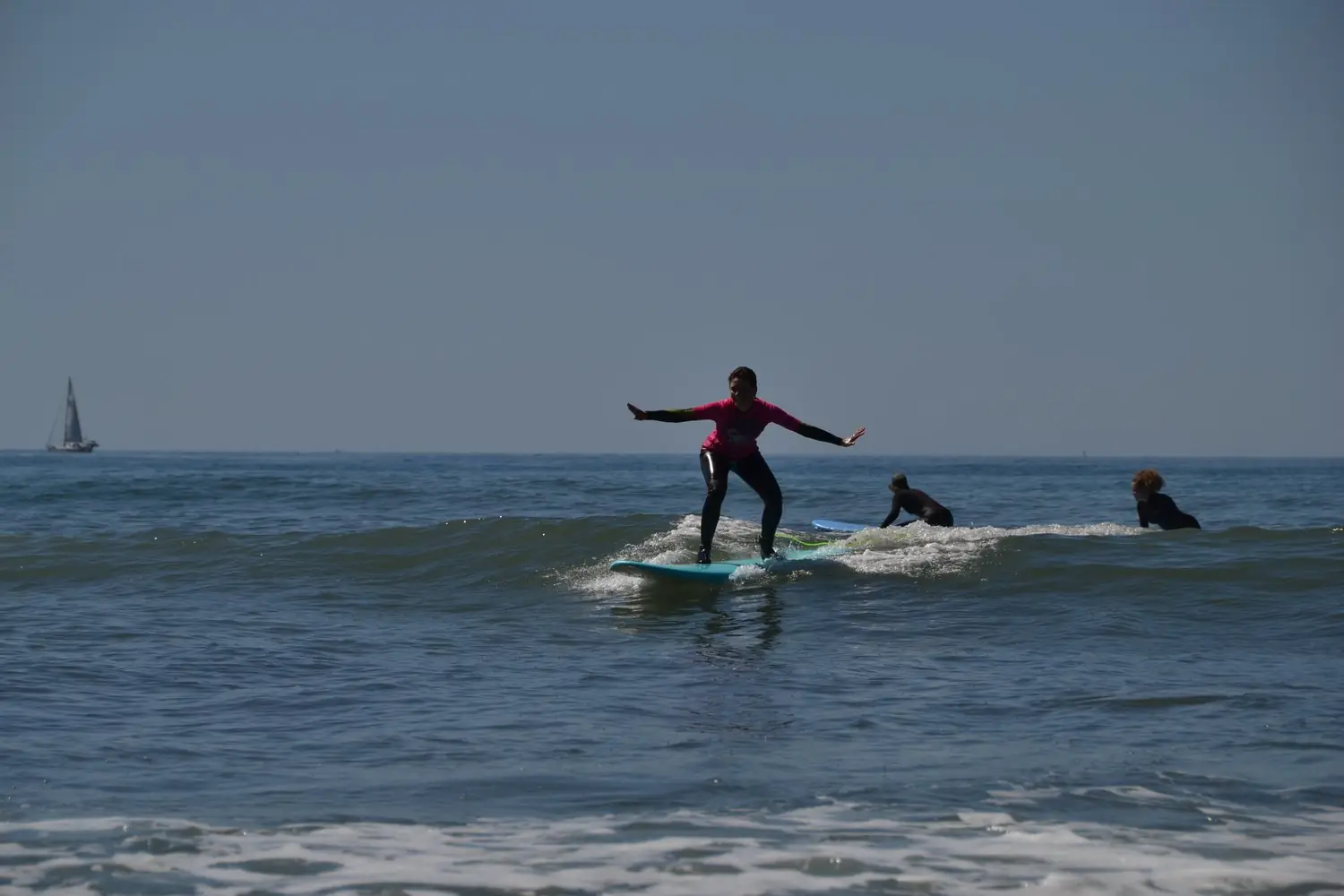 Surfer riding a wave with arms wide open