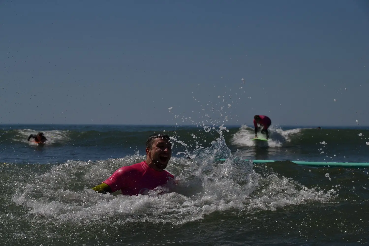 Surfer throwing spray off a wave